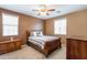 Comfortable bedroom with wood furniture and ceiling fan at 4718 E Thunderheart Trl # 103, Gilbert, AZ 85297