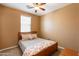 Bedroom with wood bed frame and ceiling fan at 4718 E Thunderheart Trl # 103, Gilbert, AZ 85297