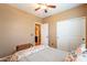 Bedroom with wood bed frame and ceiling fan at 4718 E Thunderheart Trl # 103, Gilbert, AZ 85297