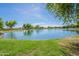 Scenic community lake with lush landscaping and walking paths at 4718 E Thunderheart Trl # 103, Gilbert, AZ 85297