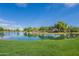Picturesque community lake surrounded by lush greenery at 4718 E Thunderheart Trl # 103, Gilbert, AZ 85297