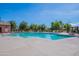 Inviting community pool with lounge chairs and umbrellas at 4718 E Thunderheart Trl # 103, Gilbert, AZ 85297