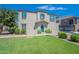 Two-story home with teal door, landscaping, and attached garage at 4718 E Thunderheart Trl # 103, Gilbert, AZ 85297