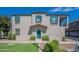 Two-story stucco home with teal front door and landscaped lawn at 4718 E Thunderheart Trl # 103, Gilbert, AZ 85297