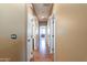 Bright hallway with wood flooring and access to bedrooms and bathrooms at 4718 E Thunderheart Trl # 103, Gilbert, AZ 85297