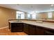 Kitchen features dark wood cabinets, granite countertops, and a breakfast bar at 4718 E Thunderheart Trl # 103, Gilbert, AZ 85297