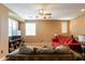 Living room featuring hardwood floors, sofas, and a TV at 4718 E Thunderheart Trl # 103, Gilbert, AZ 85297