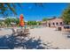 Community pool and patio furniture with a BBQ grill at 4718 E Thunderheart Trl # 103, Gilbert, AZ 85297