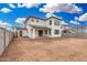 Exterior backyard view of a modern two-story home with light stucco and brown trim at 4918 W Beryl Ave, Glendale, AZ 85302
