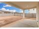 Covered patio and dirt backyard surrounded by block wall and neighborhood homes at 4918 W Beryl Ave, Glendale, AZ 85302