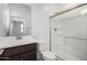 Clean bathroom featuring glass enclosed shower, dark wood vanity, and modern fixtures at 4918 W Beryl Ave, Glendale, AZ 85302