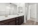 Bathroom with a double sink vanity, large mirror, and access to the toilet and shower areas at 4918 W Beryl Ave, Glendale, AZ 85302
