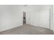 Carpeted bedroom featuring a closet with sliding doors and access to other rooms at 4918 W Beryl Ave, Glendale, AZ 85302