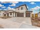 Charming two-story home with neutral colors, a three-car garage, and manicured landscaping at 4918 W Beryl Ave, Glendale, AZ 85302