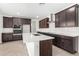Kitchen with dark wood cabinetry, stainless hood, white quartz counters, and stainless appliances at 4918 W Beryl Ave, Glendale, AZ 85302