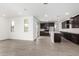 Open concept kitchen features dark wood cabinets, an island, recessed lights, and stainless appliances at 4918 W Beryl Ave, Glendale, AZ 85302