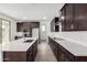 Gourmet kitchen featuring white quartz countertops, dark wood cabinets, and stainless steel appliances at 4918 W Beryl Ave, Glendale, AZ 85302