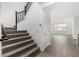 Carpeted staircase with dark wood railing, leading to an open living space at 4918 W Beryl Ave, Glendale, AZ 85302
