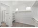 Walk-in closet equipped with shelves and clothing racks, with bathroom and shower access at 4918 W Beryl Ave, Glendale, AZ 85302