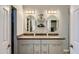 Double vanity bathroom with large mirrors and updated cabinetry at 6444 E Paradise Ln, Scottsdale, AZ 85254