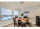 Bright breakfast nook features a wooden table and chairs, offering pool views at 6444 E Paradise Ln, Scottsdale, AZ 85254