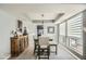 Elegant dining area with a wood cabinet and large windows at 6444 E Paradise Ln, Scottsdale, AZ 85254