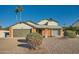 Brick home with a two-car garage and well-manicured landscaping at 6444 E Paradise Ln, Scottsdale, AZ 85254
