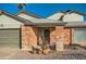 Brick front entryway with mature plants and a double door at 6444 E Paradise Ln, Scottsdale, AZ 85254