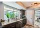 Kitchen with granite counters, dark cabinets, and a double sink at 6444 E Paradise Ln, Scottsdale, AZ 85254