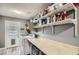 Laundry room with washer, dryer, and built-in shelving at 6444 E Paradise Ln, Scottsdale, AZ 85254