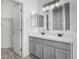 Bathroom boasts a double vanity with gray cabinets at 6903 W Irwin Ave, Laveen, AZ 85339