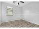 Bright bedroom with wood-look floors and ceiling fan at 6903 W Irwin Ave, Laveen, AZ 85339