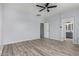 Bedroom with wood-look floors and access to bathroom at 6903 W Irwin Ave, Laveen, AZ 85339
