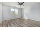 Spacious bedroom with wood-look floors and large window at 6903 W Irwin Ave, Laveen, AZ 85339