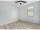 Well-lit bedroom featuring wood-look floors and a ceiling fan at 6903 W Irwin Ave, Laveen, AZ 85339