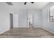 Bedroom with wood-look floors and access to bathroom at 6903 W Irwin Ave, Laveen, AZ 85339