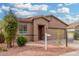 Single-story house with a two-car garage and landscaping at 6903 W Irwin Ave, Laveen, AZ 85339