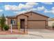 Single-story house with a two-car garage and landscaping at 6903 W Irwin Ave, Laveen, AZ 85339