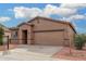 Single-story house with a two-car garage and landscaping at 6903 W Irwin Ave, Laveen, AZ 85339