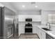 Modern kitchen with stainless steel appliances and white cabinets at 6903 W Irwin Ave, Laveen, AZ 85339