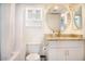 Bathroom featuring white vanity with granite countertop and a decorative round mirror at 7970 E Camelback Rd # 101, Scottsdale, AZ 85251