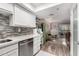 Updated kitchen with white cabinets and view into living area at 7970 E Camelback Rd # 101, Scottsdale, AZ 85251