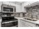 Modern kitchen features stainless steel appliances and stylish backsplash at 7970 E Camelback Rd # 101, Scottsdale, AZ 85251