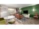 Living room with a green accent wall, comfortable seating and a large TV at 7970 E Camelback Rd # 101, Scottsdale, AZ 85251