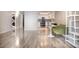 Spacious living room showing the kitchen, featuring wood floors and an open floorplan at 7970 E Camelback Rd # 101, Scottsdale, AZ 85251