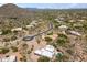 A neighborhood view with a home featuring a pool and landscaped backyard among native desert vegetation at 8300 E Dixileta Dr # 281, Scottsdale, AZ 85266
