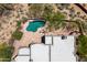 An overhead view of a home with a pool and patio, complemented by lush landscaping and desert terrain at 8300 E Dixileta Dr # 281, Scottsdale, AZ 85266