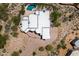 An aerial shot showcasing a home's rooftop, backyard pool, and surrounding desert landscape at 8300 E Dixileta Dr # 281, Scottsdale, AZ 85266