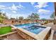 Stunning backyard oasis featuring a large pool, spa, and water features at 1318 W Medinah Ct, Anthem, AZ 85086