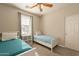 Well-lit bedroom featuring twin beds, ceiling fan, and window coverings at 1342 E Verde Blvd, Queen Creek, AZ 85140